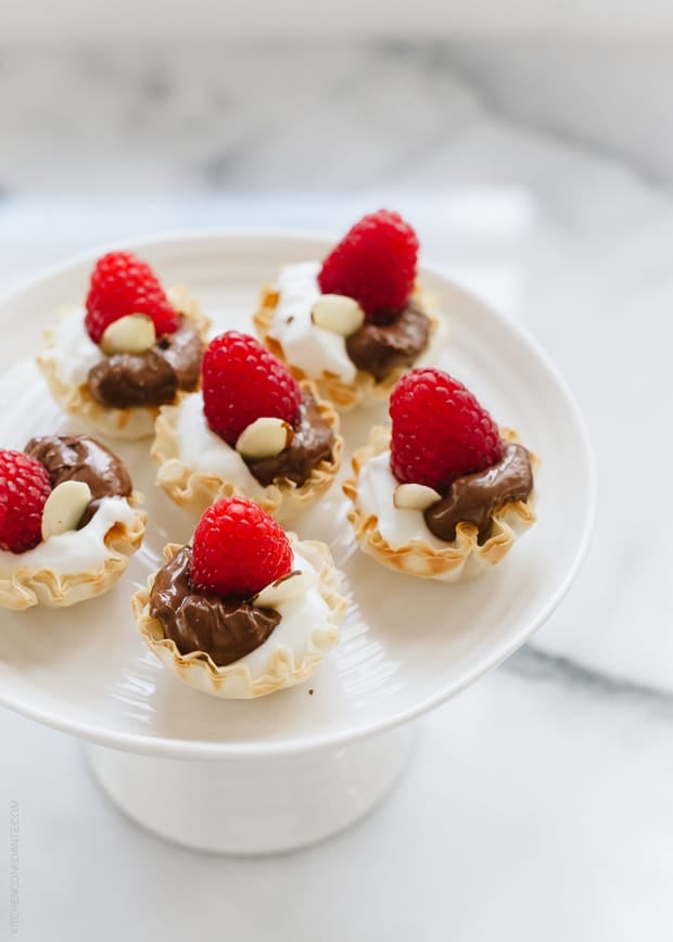 A white cake stand arranged with treats for entertaining!