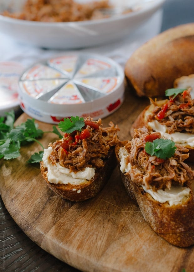 Pulled Pork Bruschetta on a wooden serving board.