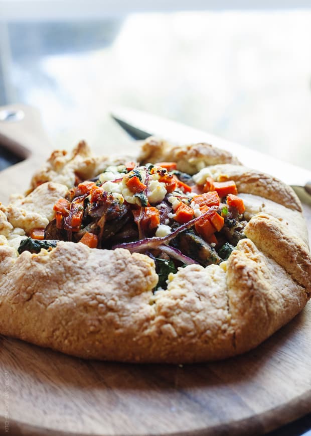 A Savory Chicken Sausage and Vegetable Galette on a wooden serving board.