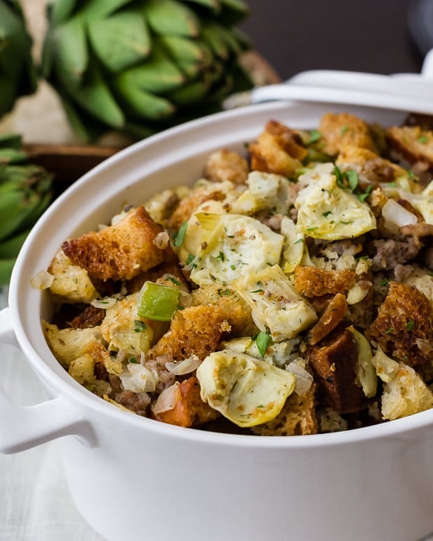 Artichoke Sourdough Stuffing with Jones Sausage in a large white serving dish.