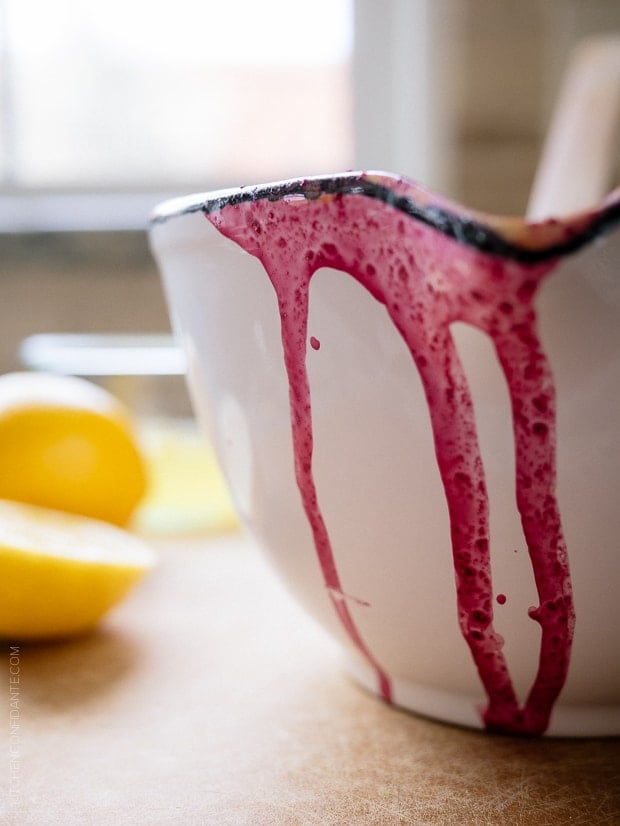 A white bowl with blueberries staining the side.