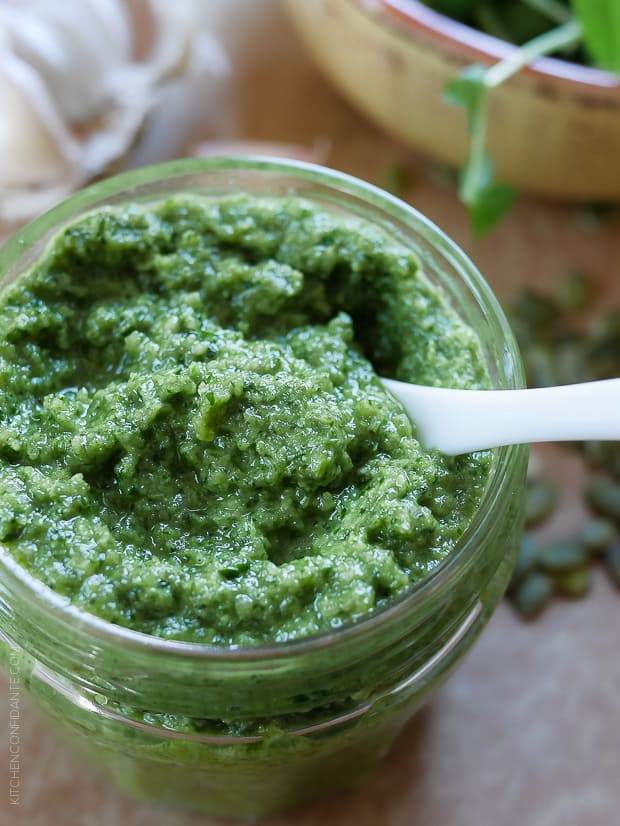 A glass jar filled with Pea Shoot and Pumpkin Seed Pesto. 