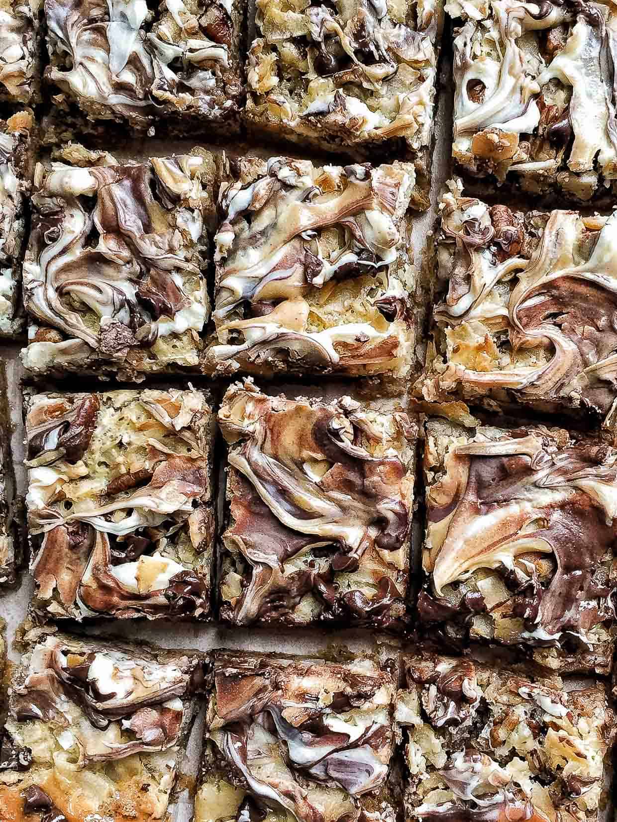 Close up view of freshly baked 7 Layer Bars cut into rectangles.