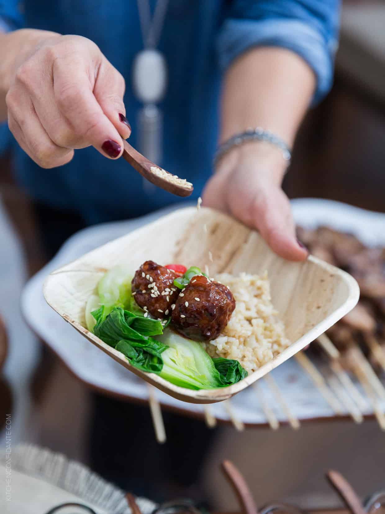 Sprinkling sesame seeds on a Spicy Korean Meatball Bowl!