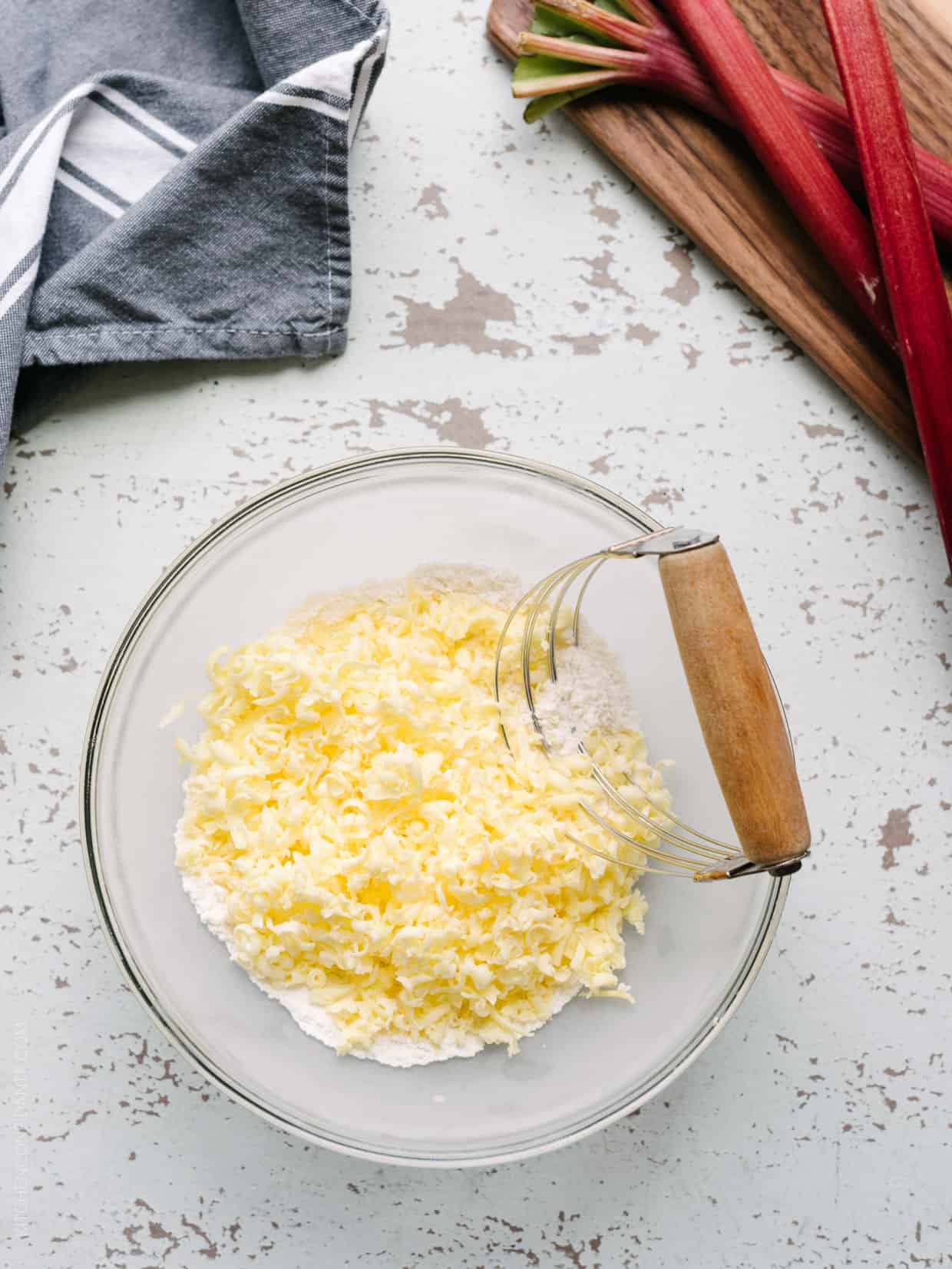 Glass bowl filled with grated butter.