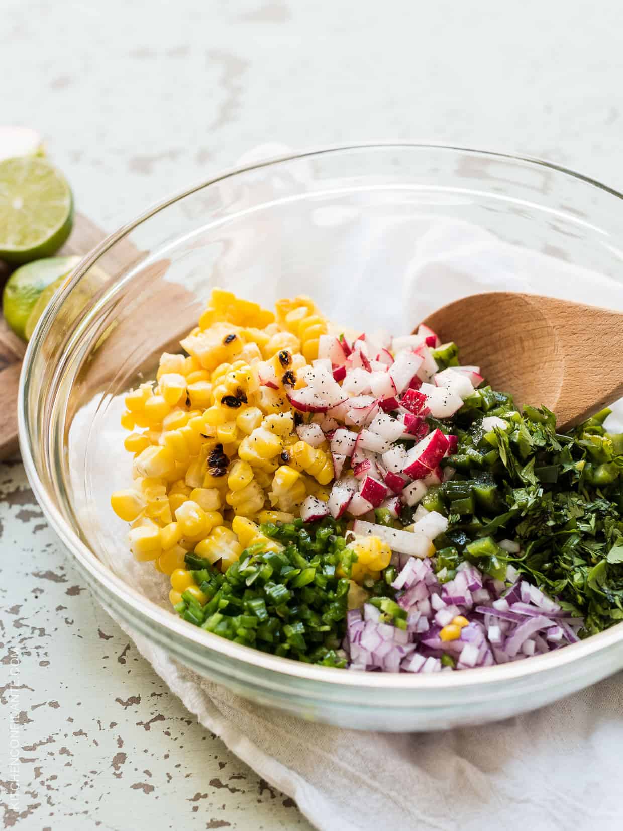 Grilled Corn and Poblano Salad about to be stirred together in a glass bowl.