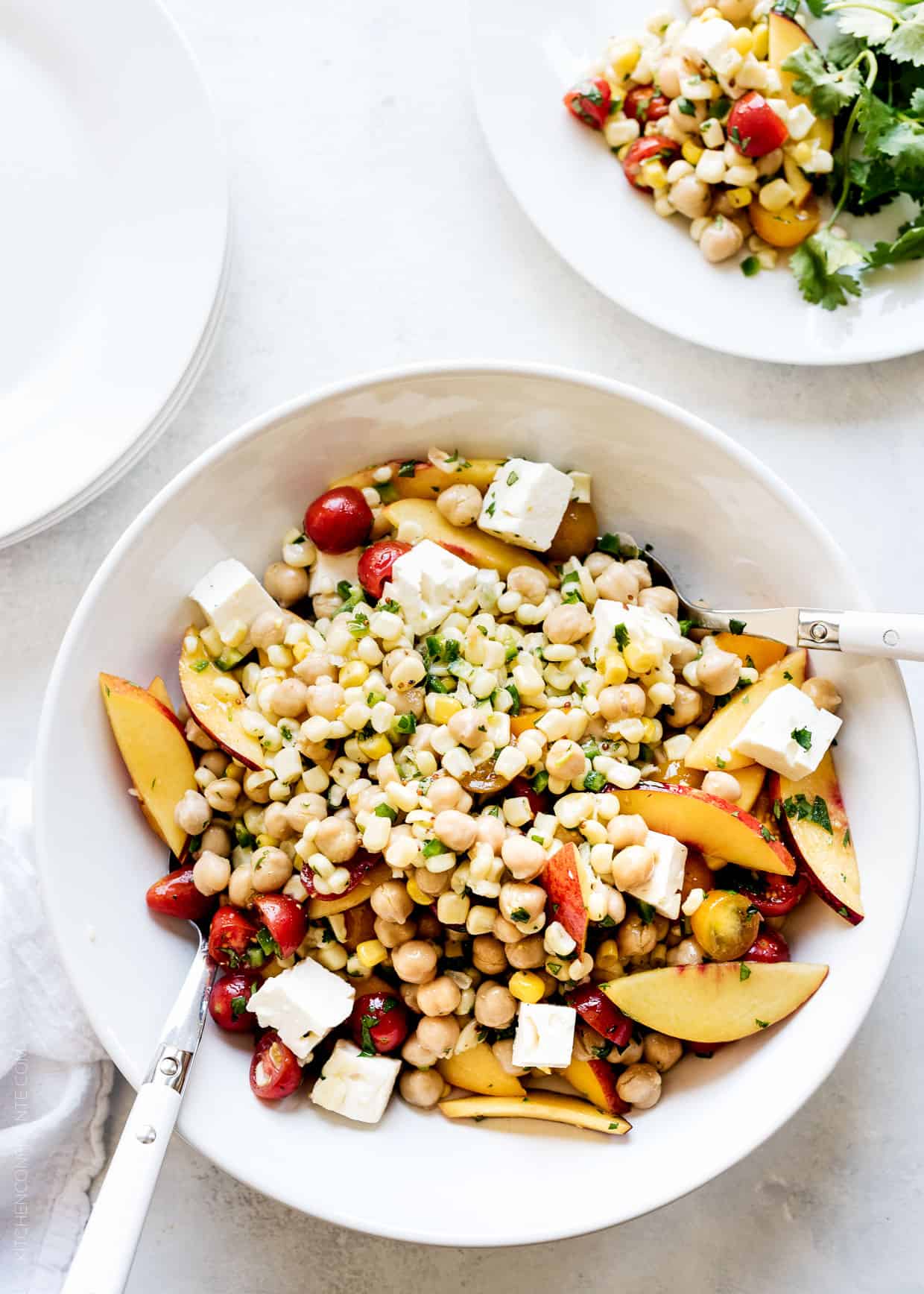Tomato, Corn and Nectarine Chickpea Salad -- all of your favorite summer fruits and vegetables, in a vibrant summer salad! This is guaranteed to become a go-to all season long.