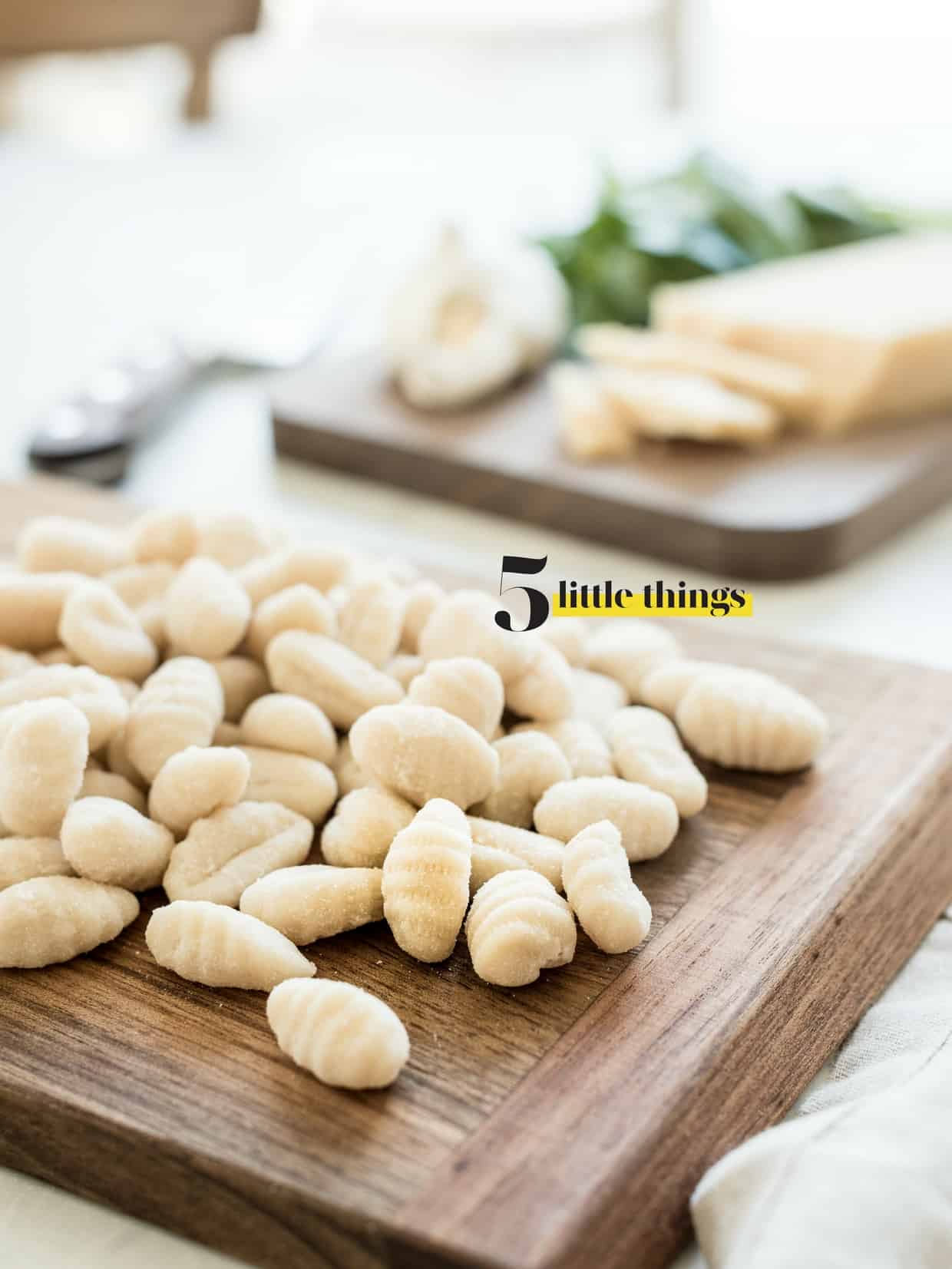 Fresh gnocchi on a wooding cutting board.