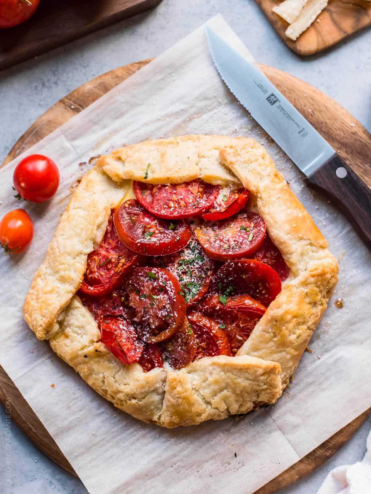 A freshly baked Tomato Ricotta Galette on parchment paper.