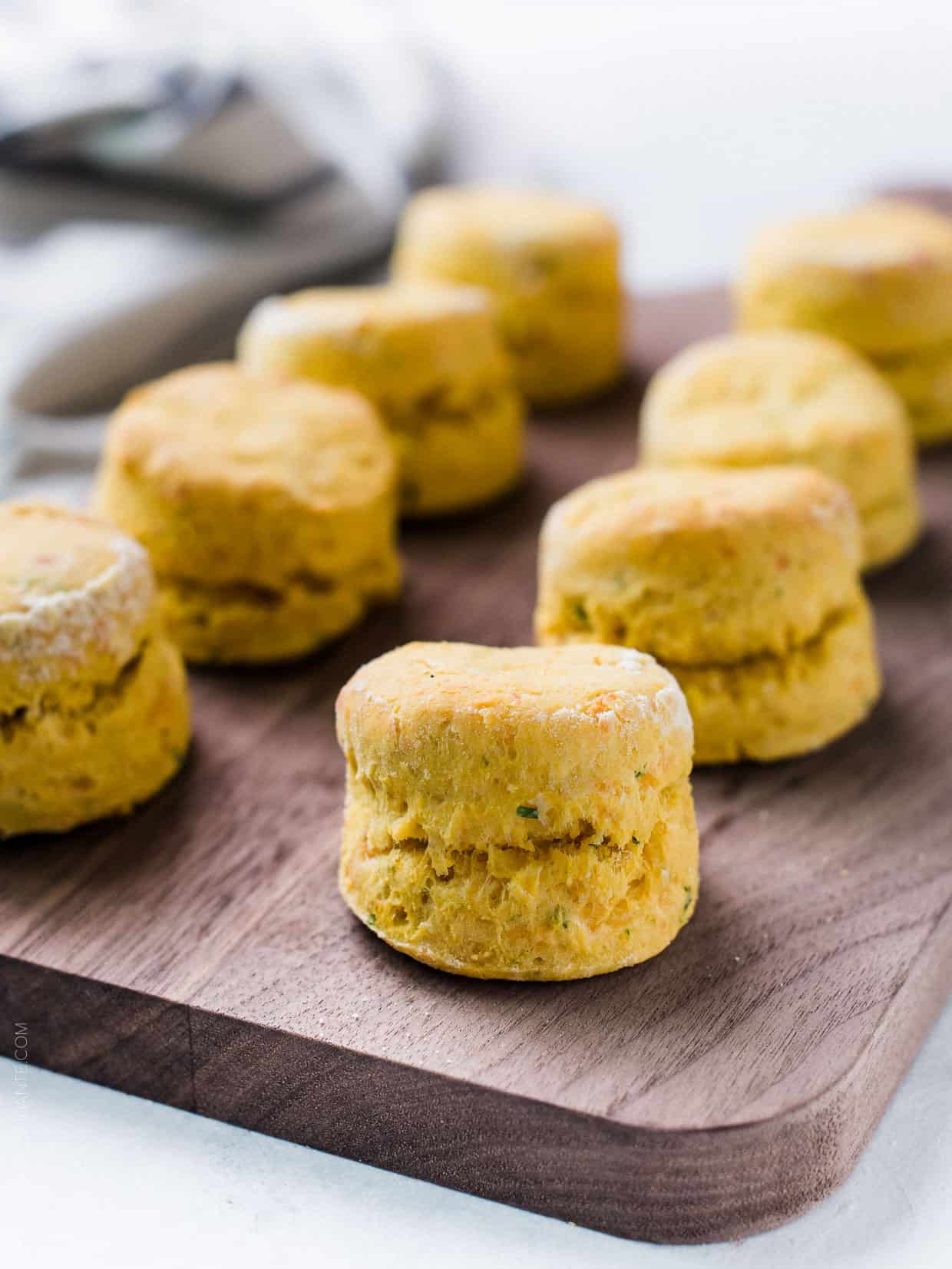 Pumpkin Cheddar Biscuits freshly baked and served on a wooden board.