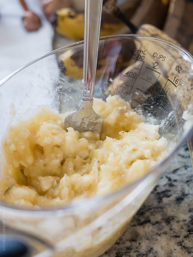 Mashed banana in a measuring cup for Banana Pineapple Cake.