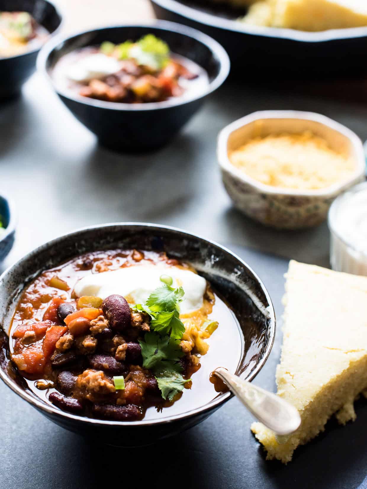 Classic Chili garnished with shredded cheese, sour cream, green onions and cilantro. 