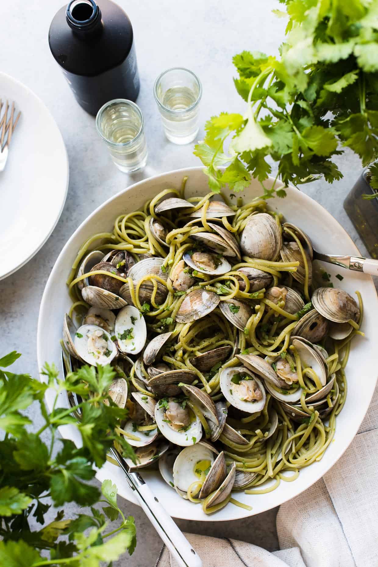 Linguine with Clams in Sake Red Chili Sauce in serving bowl with cilantro.