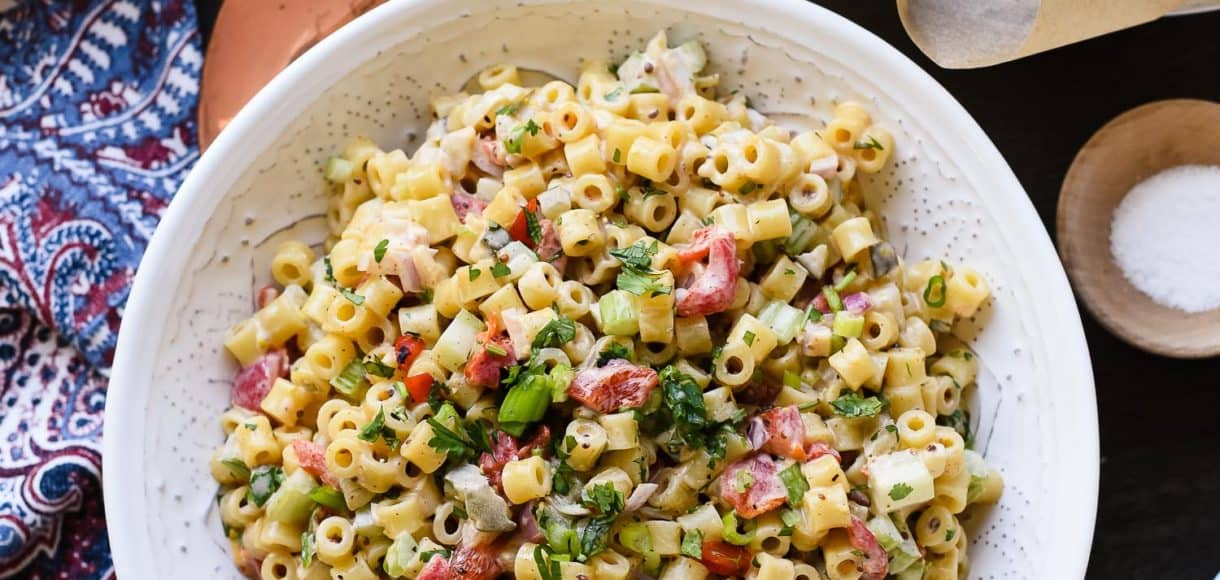 Fireworks Pasta Salad in a white bowl at a picnic