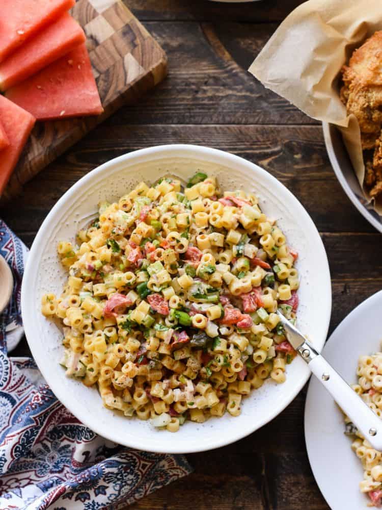 Fireworks Pasta Salad in a white bowl at a picnic