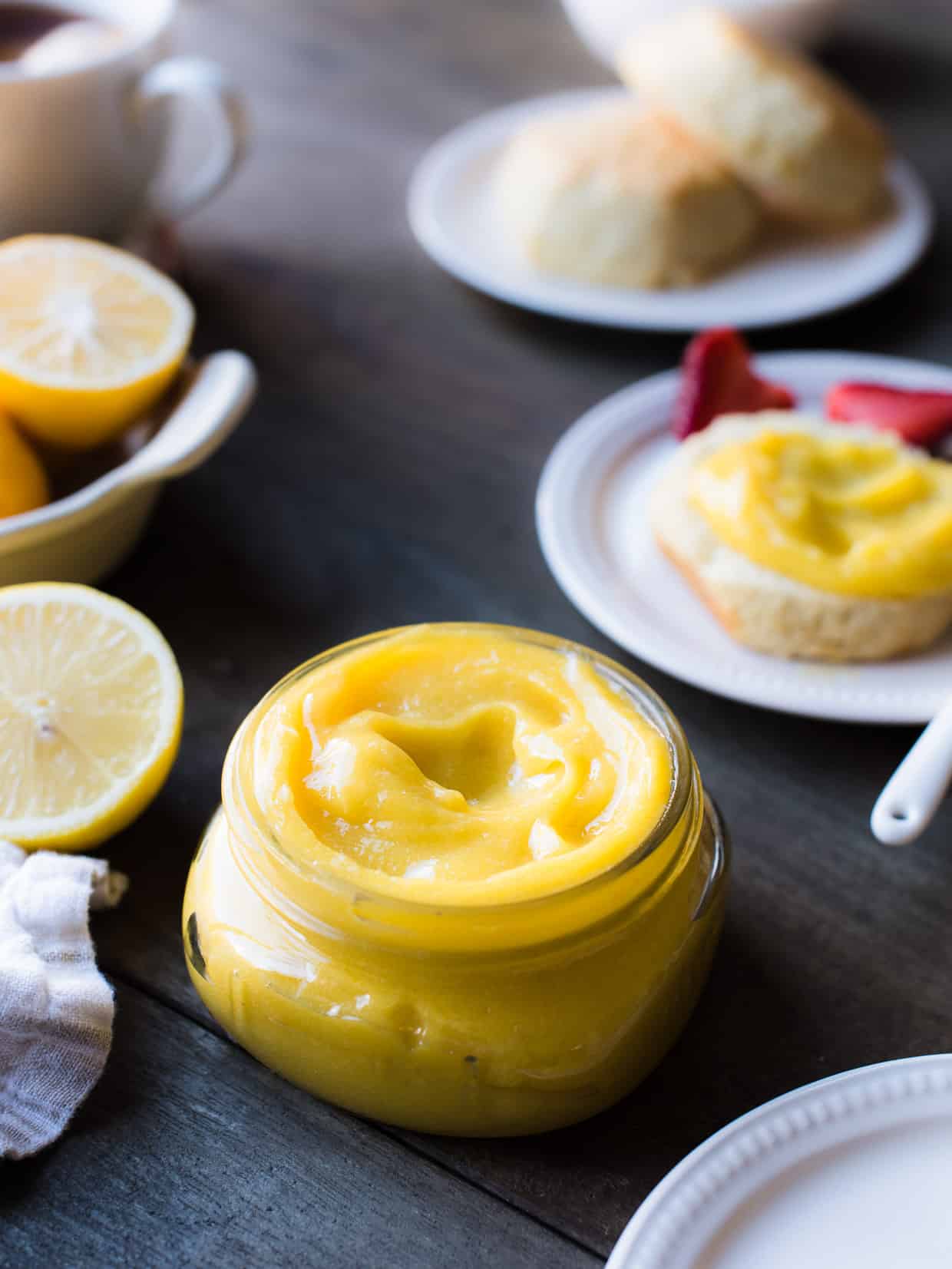 Lemon curd in a jar, with scones.