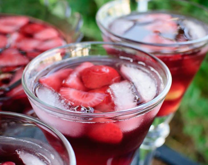 Summer Sangria with Rum with fruit and ice cubes in a clear glass