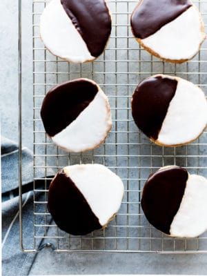 The Black and White Cookie - a New York deli classic. Frosted with vanilla and chocolate icing, these cake-like cookies delivers the best of both worlds.