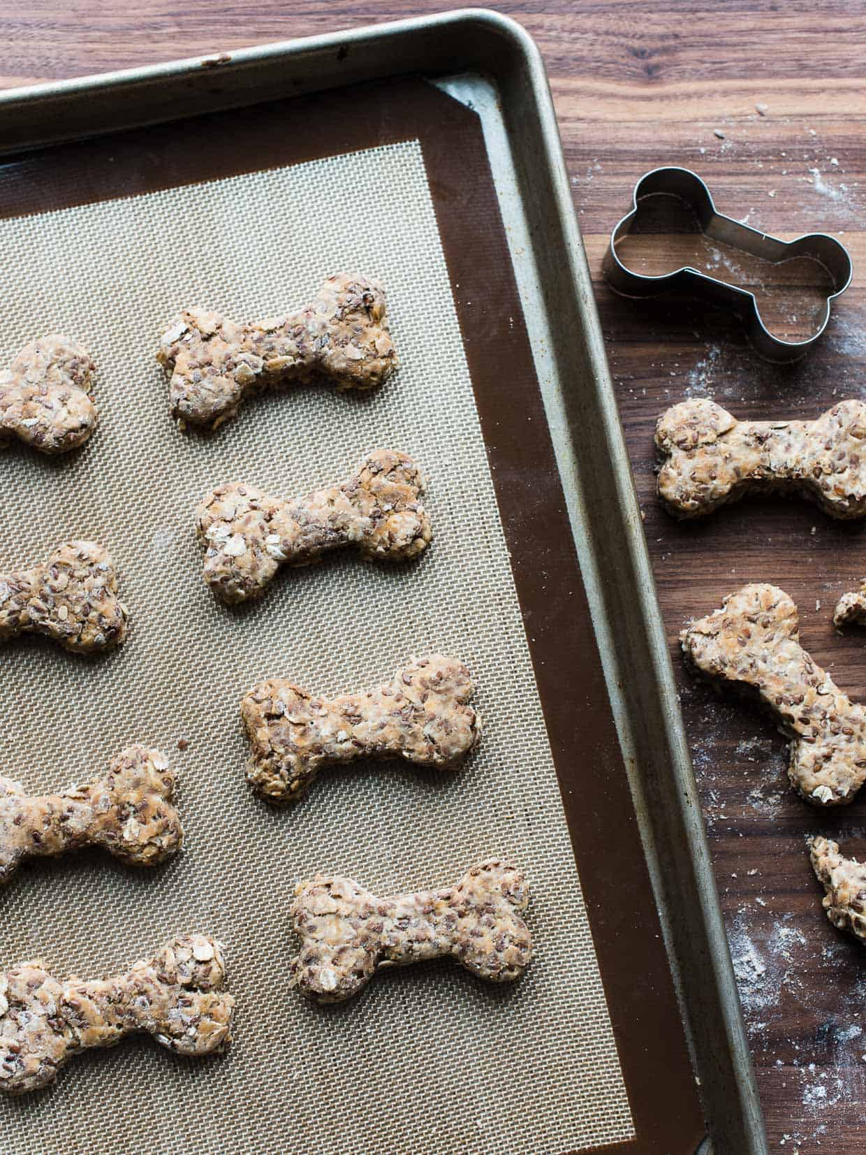 Cutting out homemade dog biscuits with a cookie cutter.