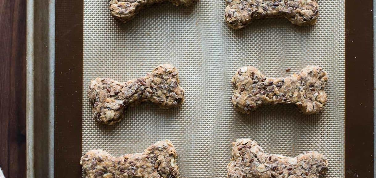 Overhead shot of homemade dog biscuits on baking sheet.