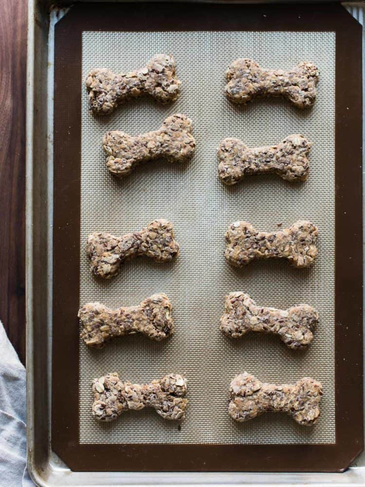 Overhead shot of homemade dog biscuits on baking sheet.