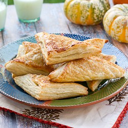 A plate of pumpkin turnovers fresh out of the oven.