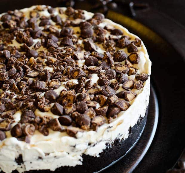 An icebox cake layered with vanilla ice cream and chocolate sandwich cookies and topped with peanut butter cups.