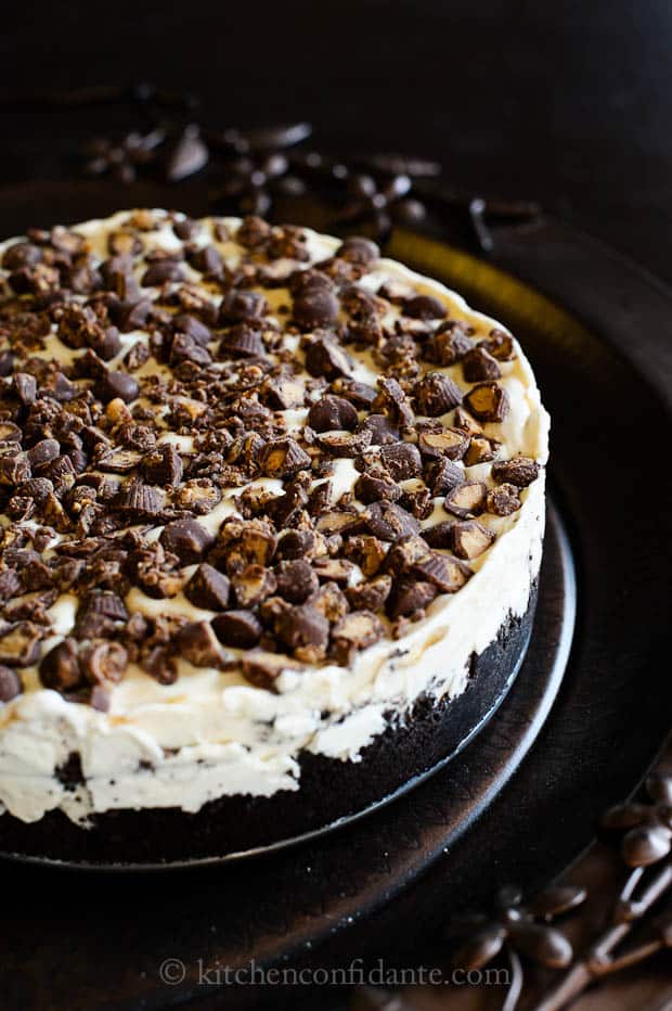 An icebox cake layered with vanilla ice cream and chocolate sandwich cookies and topped with peanut butter cups.