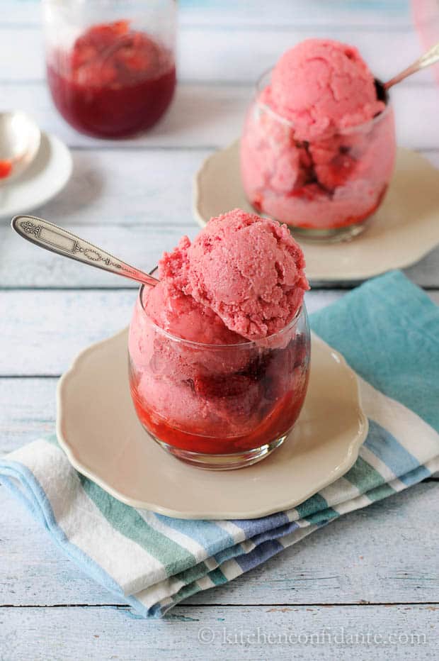 Glasses of strawberry sauce and homemade strawberry frozen yogurt.