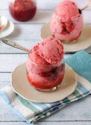 Glasses of strawberry sauce and homemade strawberry frozen yogurt.