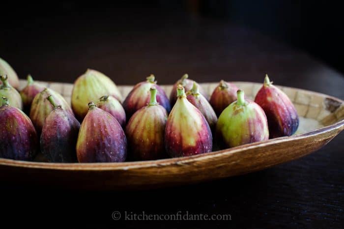 Wooden bowl with figs.