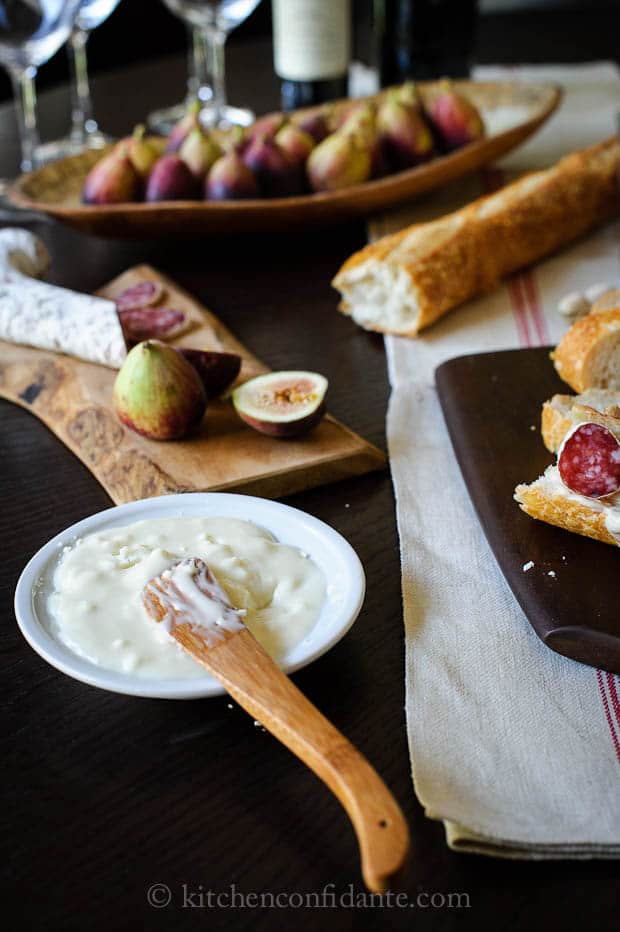 A bowl of honeyed goat cheese ready to create Goat Cheese Crostini with Figs and Honey.