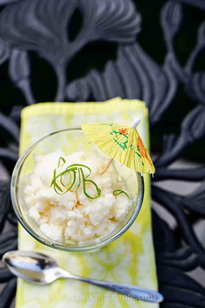 A pina colada granita with a yellow cocktail umbrella.