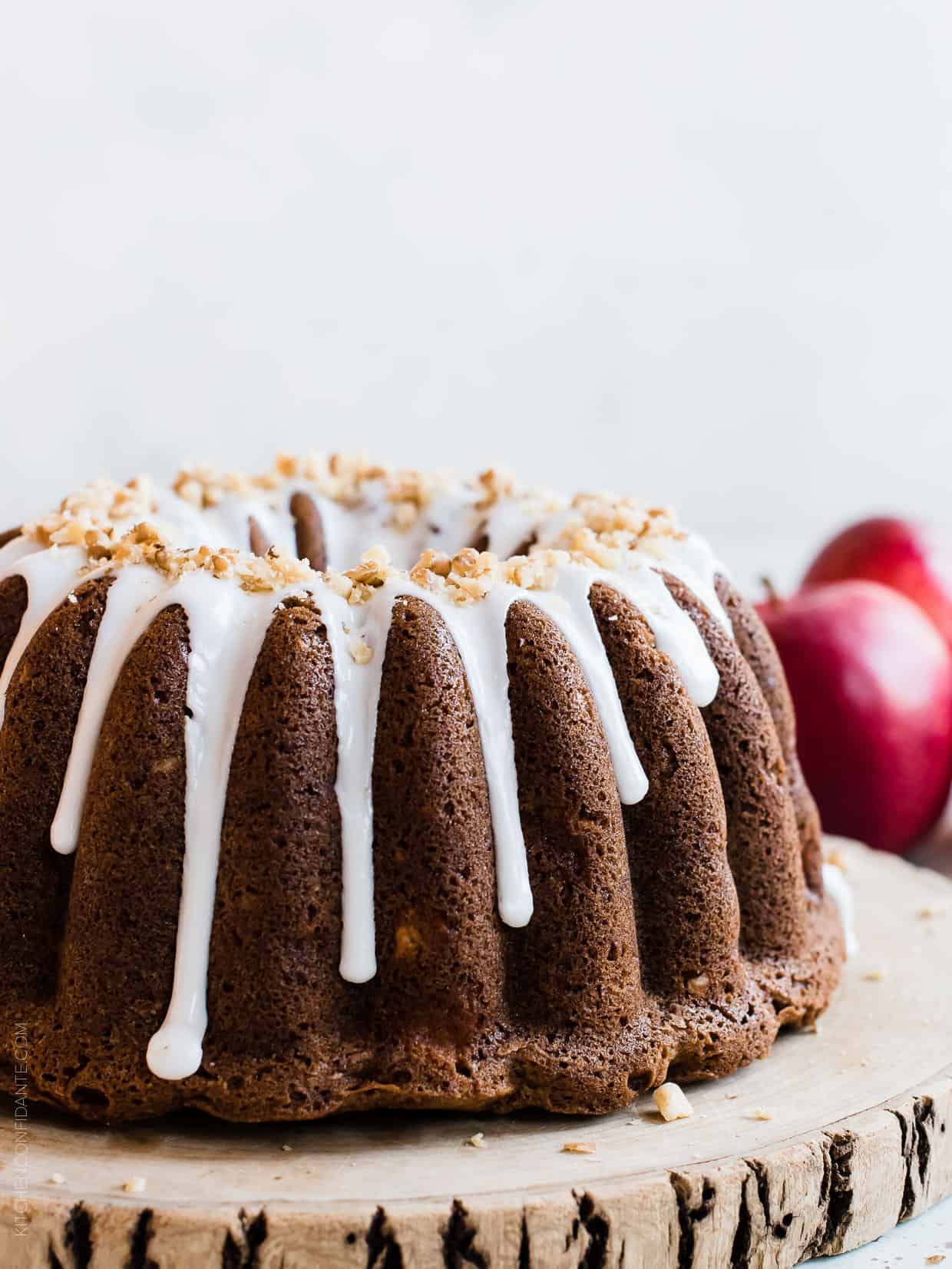 Apple Walnut Cake with apples in the background.