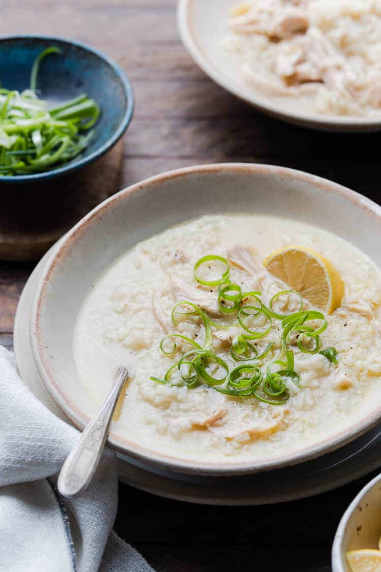 A bowl of Arroz Caldo, Filipino Chicken and Rice Soup, topped with scallions