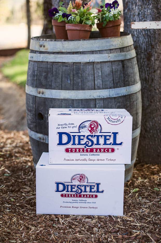 Diestel Boxes stacked beside a wooden barrel.