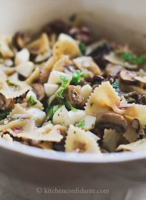 Warm Eggplant & Mushroom Pasta Salad in a white bowl ready to eat.
