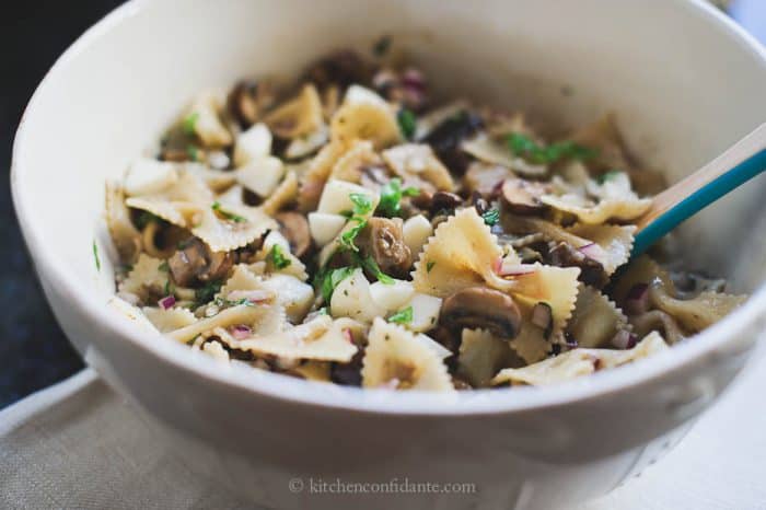 Warm Eggplant & Mushroom Pasta Salad in a white bowl ready to eat.