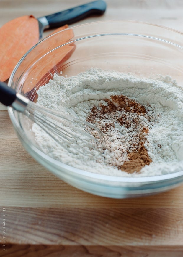 Adding fall spices to the dry ingredients for Sweet Potato Pancakes.