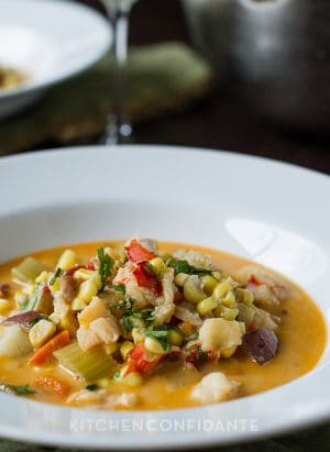A white dish of lobster corn chowder.