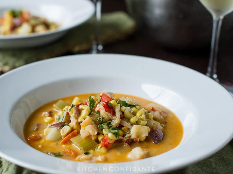 A white dish of lobster corn chowder.