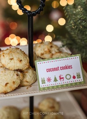 A decorative tiered stand full of cokies. A red and green sign says "coconut cookies".
