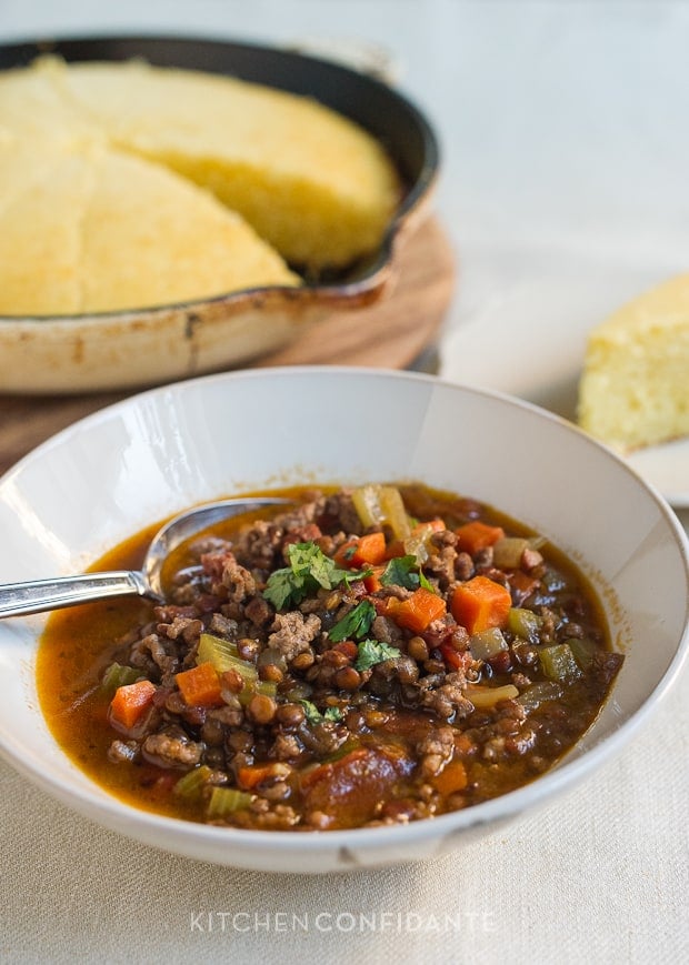 A bowl filled with hearty homemade beef and lentil chili.