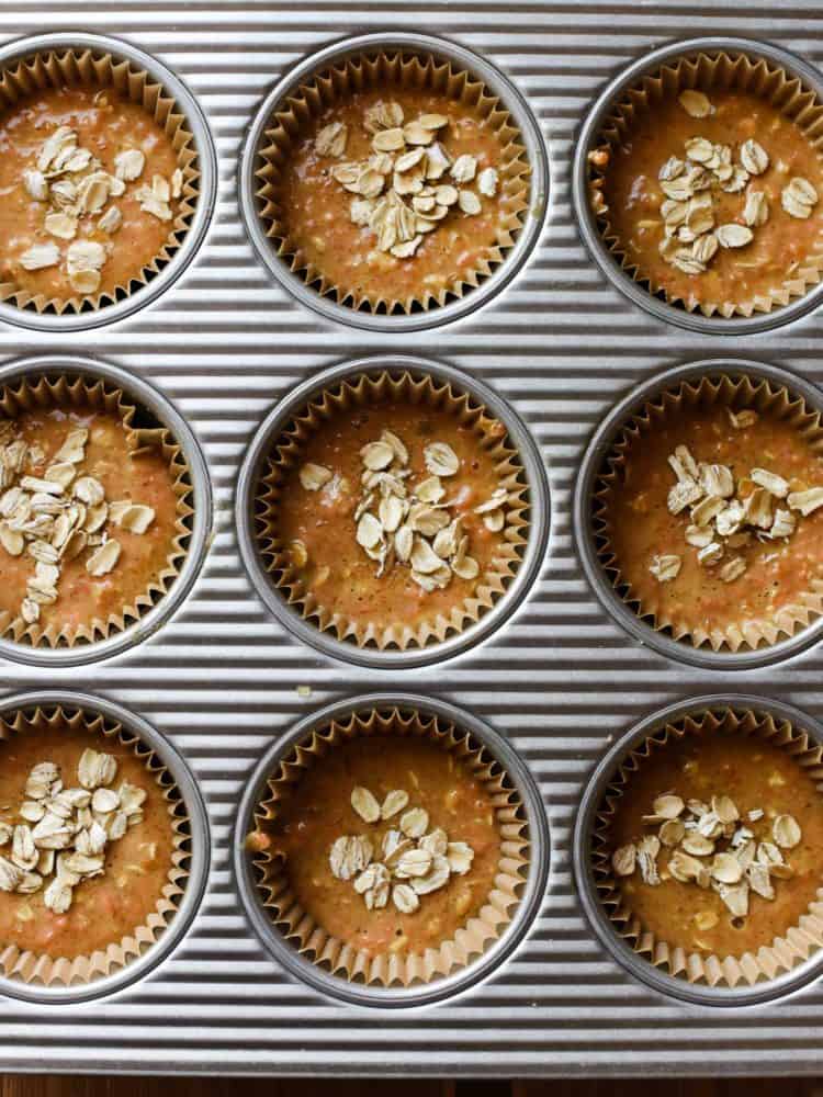 Batter for Carrot Oat Muffins in a muffin pan.