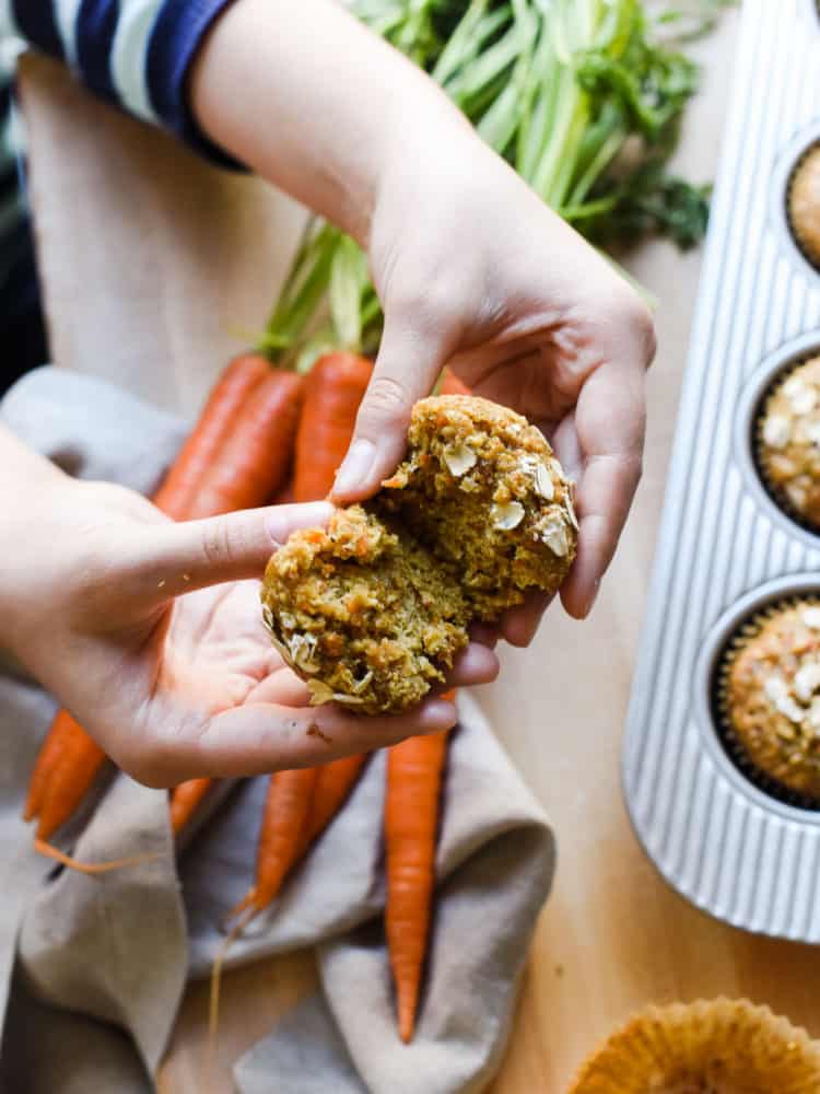 Breaking apart a Carrot Oat Muffin.