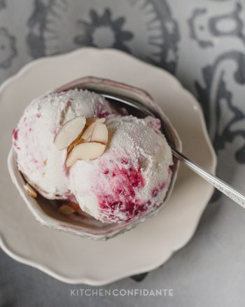 A bowl with two scoops of Cranberry Almond Swirl Ice Cream.