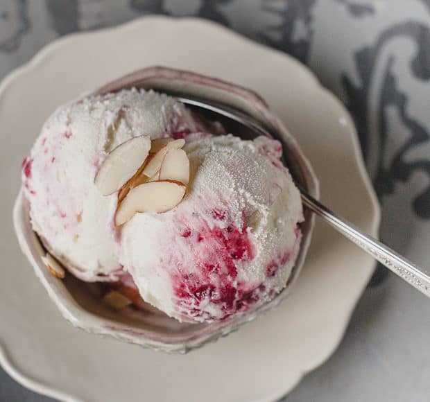 A bowl with two scoops of Cranberry Almond Swirl Ice Cream.