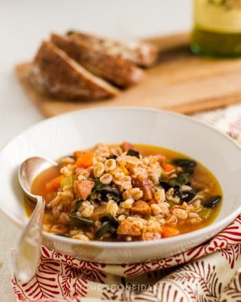 A bowl of Farro Soup with Red Chard and Sausage.