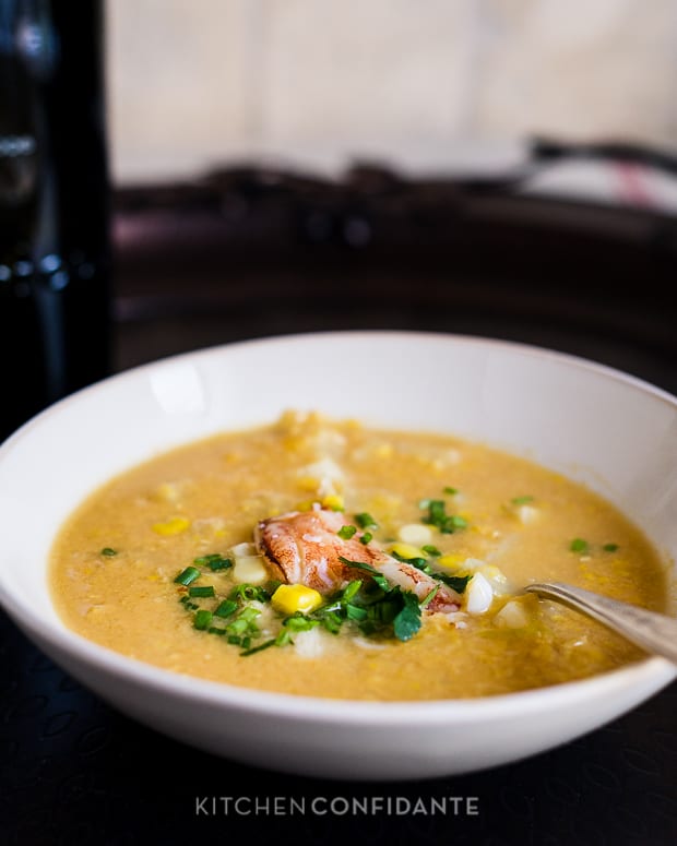 A white bowl filled with crab and corn chowder.