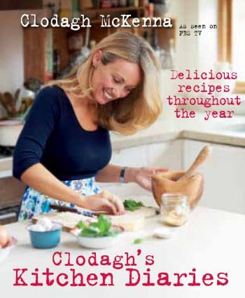 The cover of Clodagh's Kitchen Diaries, a cookbook showing Irish chef Clodagh McKenna preparing a recipe.